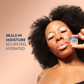 Vaseline Lip Therapy Cocoa Butter mini lip balm in hand