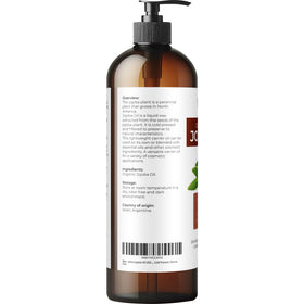 velona Jojoba Oil 16 fl oz with pump on a wooden surface