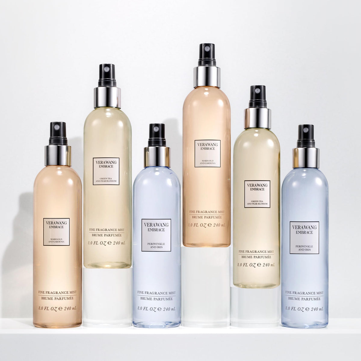 Vera Wang Embrace Body Mist surrounded by green tea leaves
