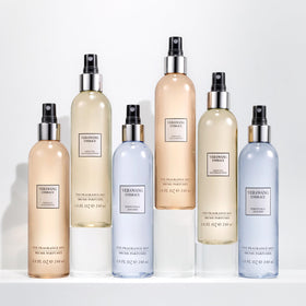 Vera Wang Embrace Body Mist surrounded by green tea leaves