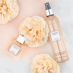 Vera Wang Embrace Marigold & Gardenia Body Mist with floral background