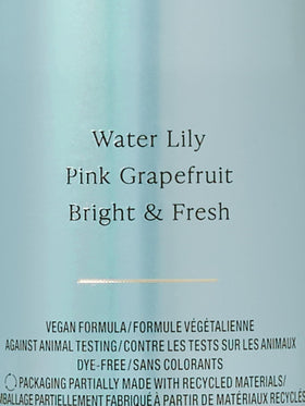 Victoria's Secret Aqua Kiss Body Mist with fresh daisies in the background