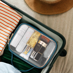 Wedama toiletry bags in a travel setting with suitcase