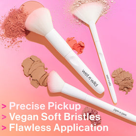 wet n wild Powder Brush in a makeup setup with various products