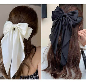 White hair bow clip styled in a half-up hairstyle
