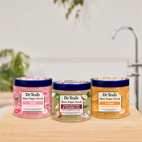 Woman using Dr Teal's Shea Sugar Scrub in the shower