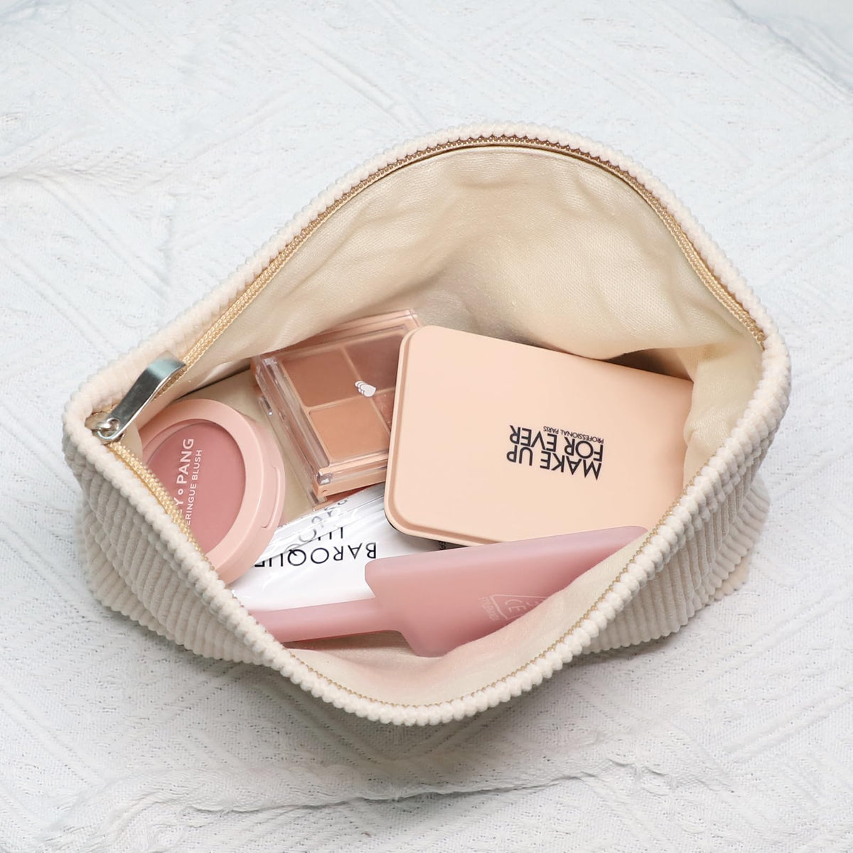 Wudygirl Makeup Bag placed on a vanity with cosmetics