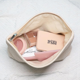 Wudygirl Makeup Bag placed on a vanity with cosmetics