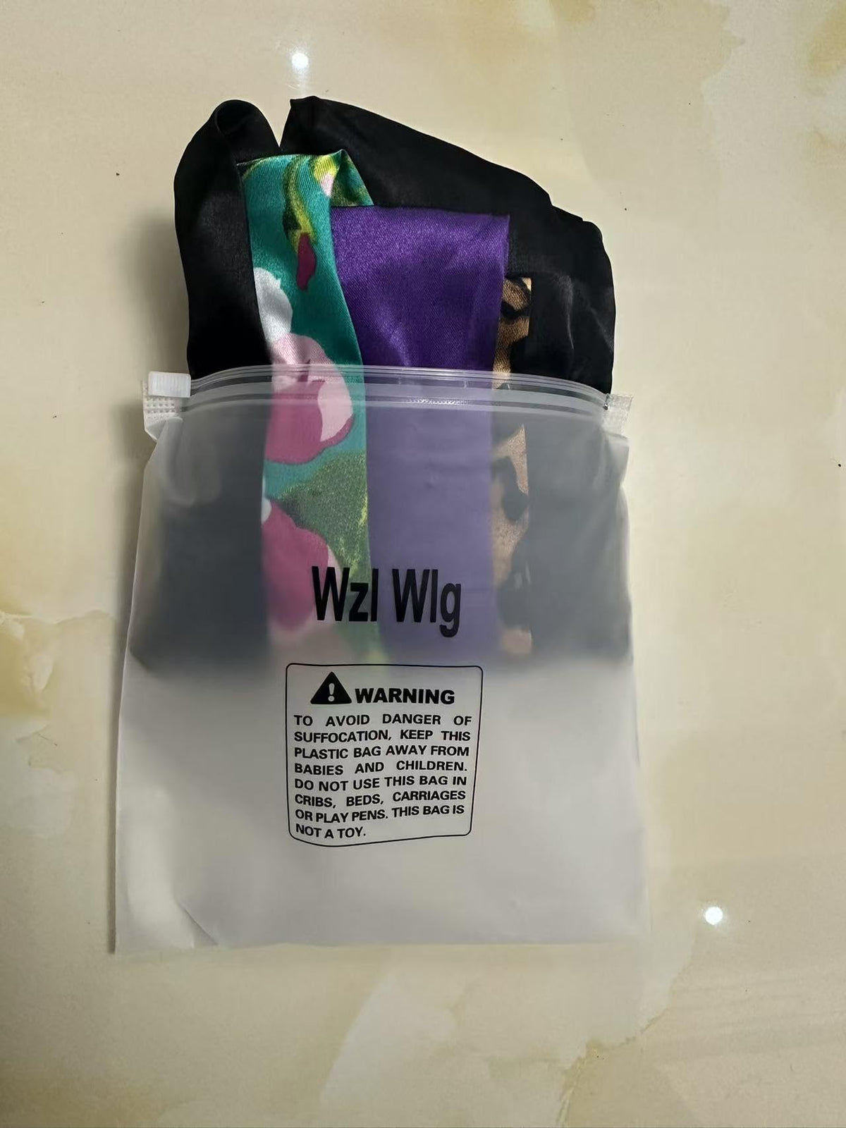 Wzl Wlg satin bonnets shown with a measuring tape for size reference