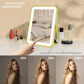 YEKKOPT Gold Rechargeable Mirror on a vanity with makeup tools