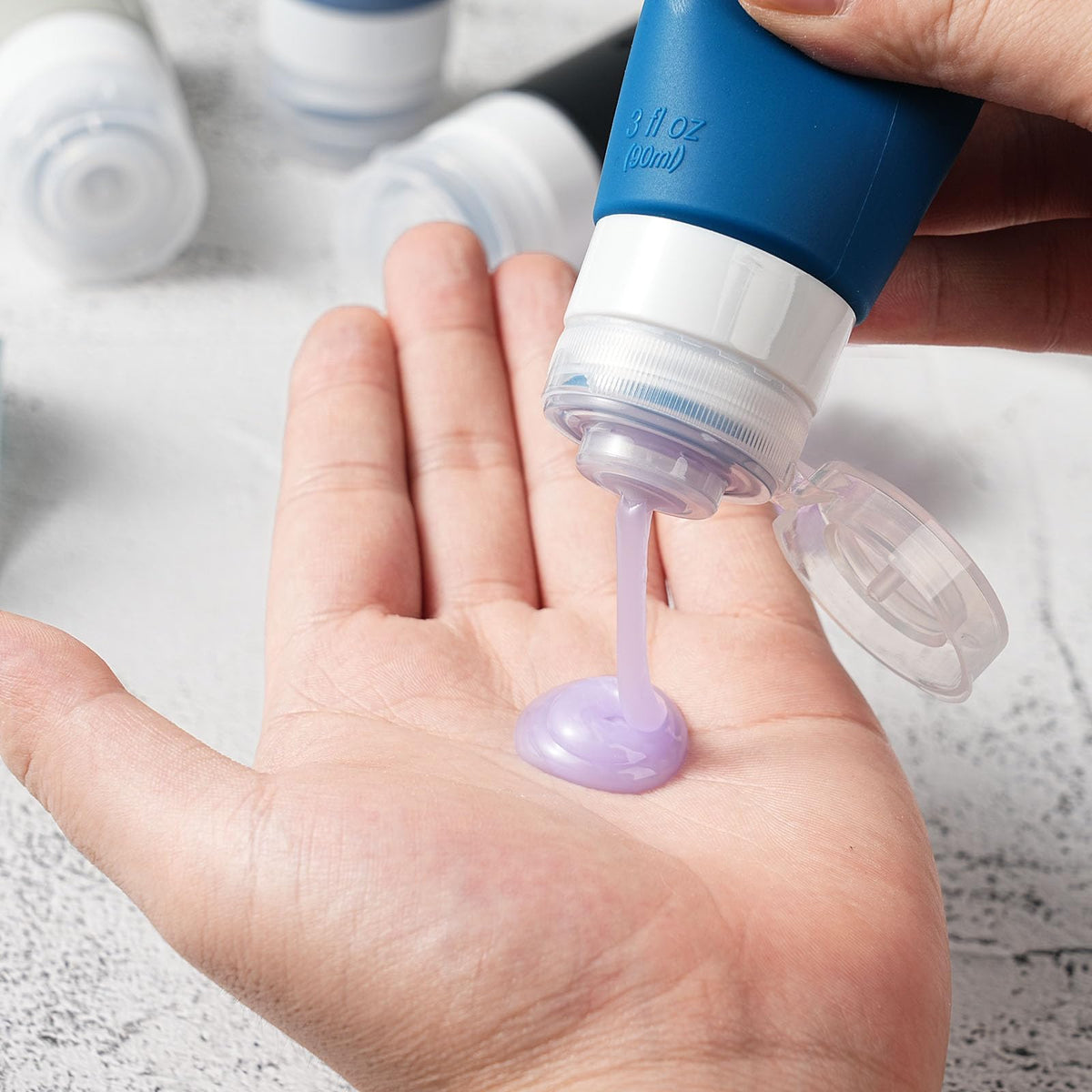 Zafit travel bottles showing leak-proof design and filling process