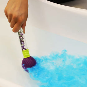 ZIMPLI Baff Bombz Magic Brush bath bomb being held by a child